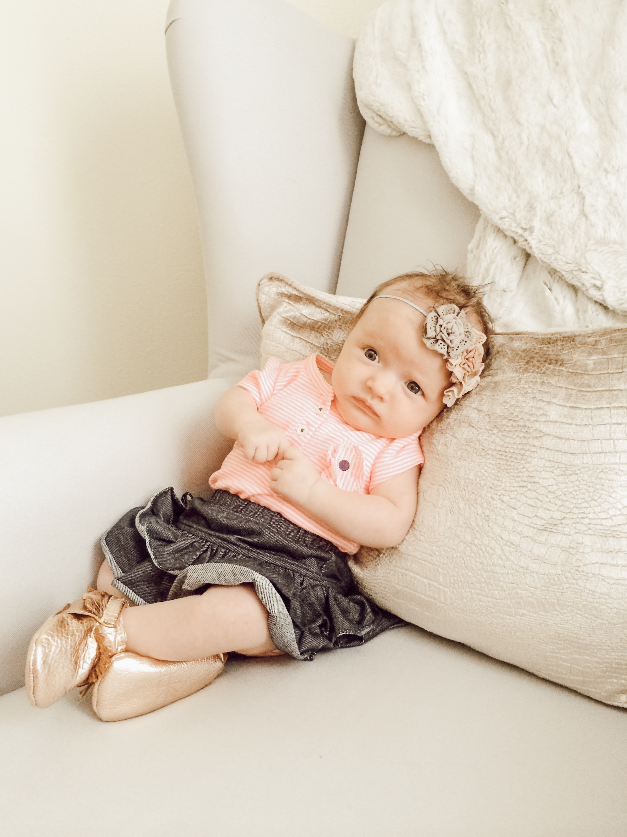Newborn baby girl with freshly picked moccassins and headband