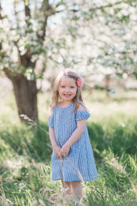 toddler in cherry blossoms